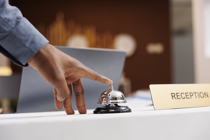 hotel-guest-at-empty-reception-desk-2024-02-26-22-07-59-utc